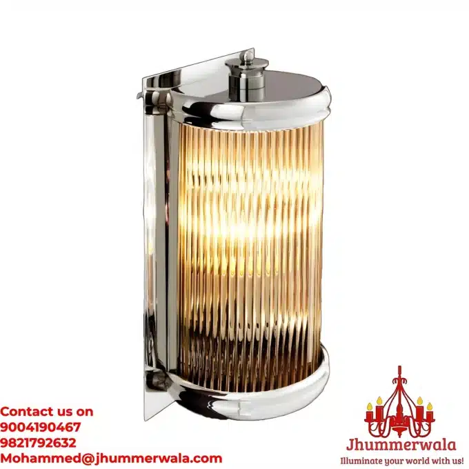 Silver Serenity Brass Sconce Petite. A close-up view of a designer wall lamp with a sleek metal finish and textured glass.