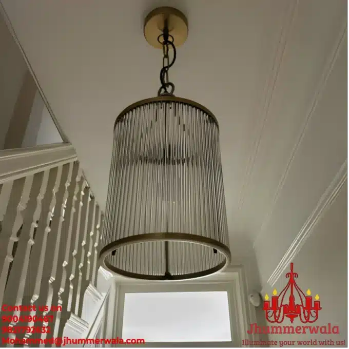 Elegant "Rodance Chandelier" with glass rods and matte gold brass fitting, perfect for luxurious living spaces.